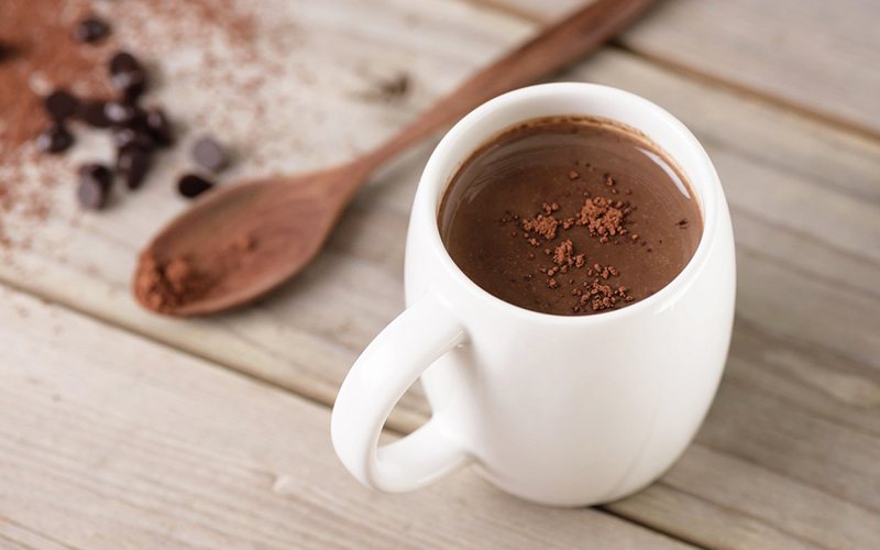 A cup of coffee on a table

Description automatically generated